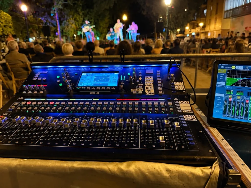 Allen & Heath SQ-6 digital mixing desk at the sound control position of an outdoor concert